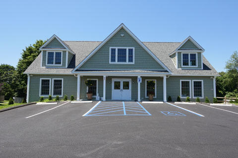 Green shingle building, parking lot. Green shingle building, parking lot.